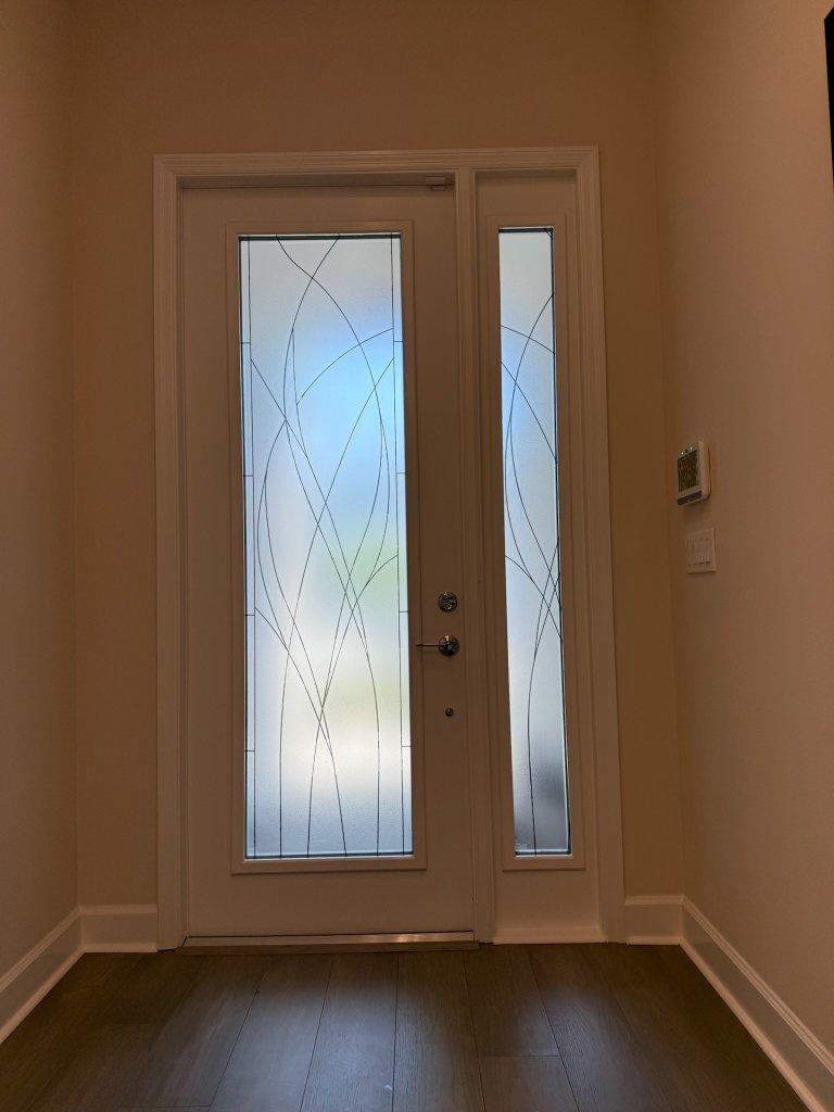 Fine sweeping lines on an entry door and sidelight