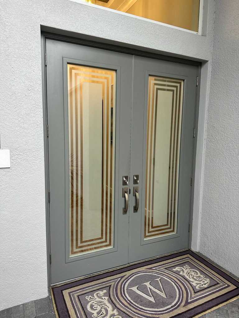 Warm-toned nested rectangular borders on double entry doors
