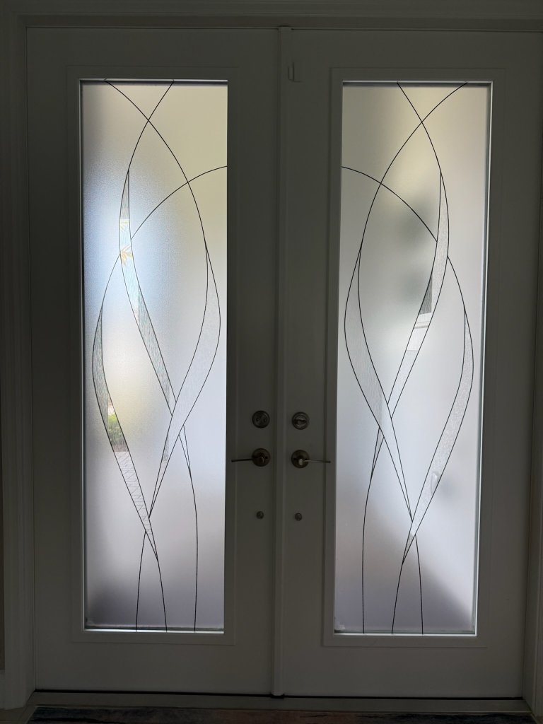 Sweeping curved linework on frosted double entry doors