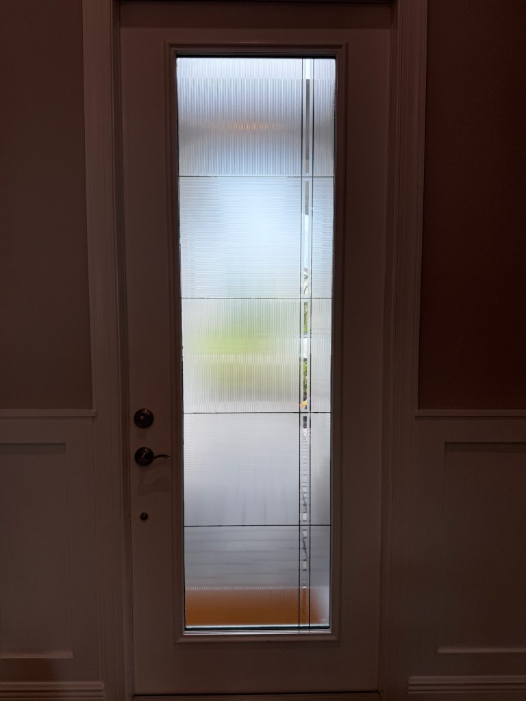 Rectangular frost and clear linework on a narrow entry door
