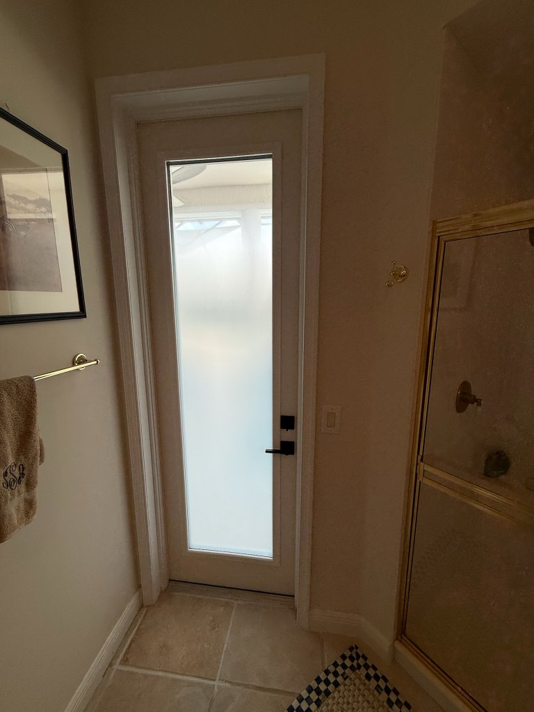 Frosted glass privacy door in a bathroom