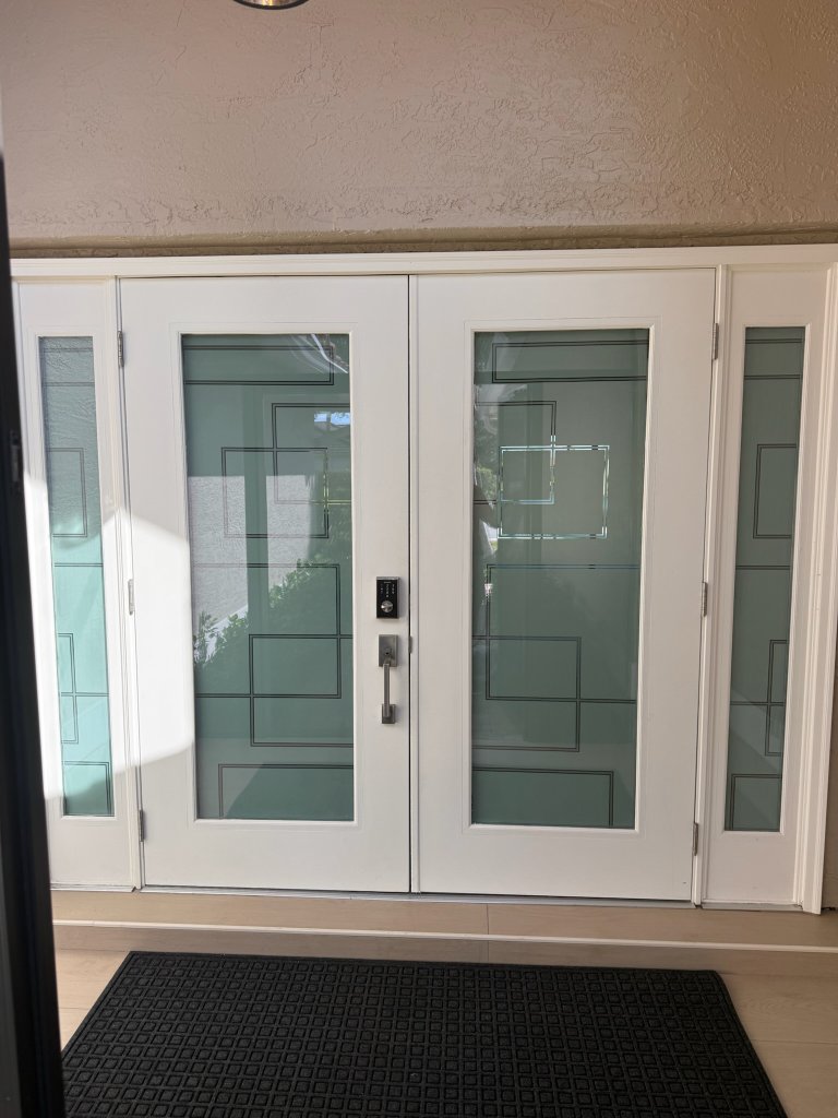 Frosted geometric treatment on white double entry doors