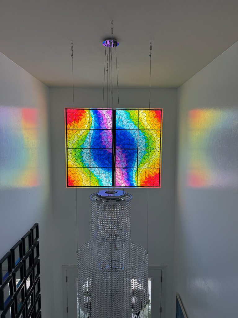 Colorful stained-glass-effect artwork in a shower window