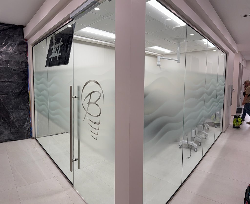 Branded logo and horizontal decorative bands on commercial glass