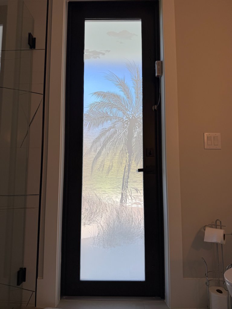Palm artwork on a tall entry-door pane