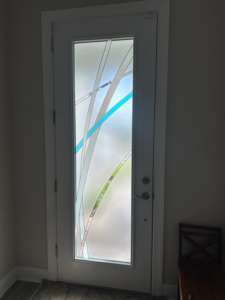 Blue diagonal accents on a narrow entry-door pane