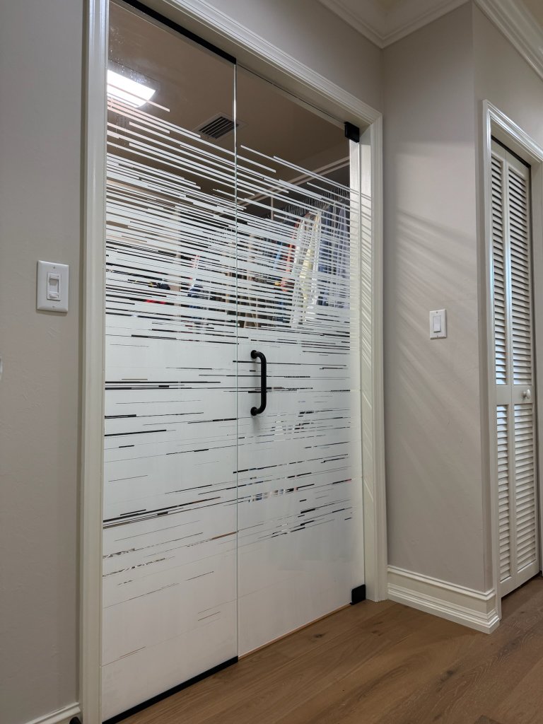 Horizontal clear-and-frosted bands on a shower door