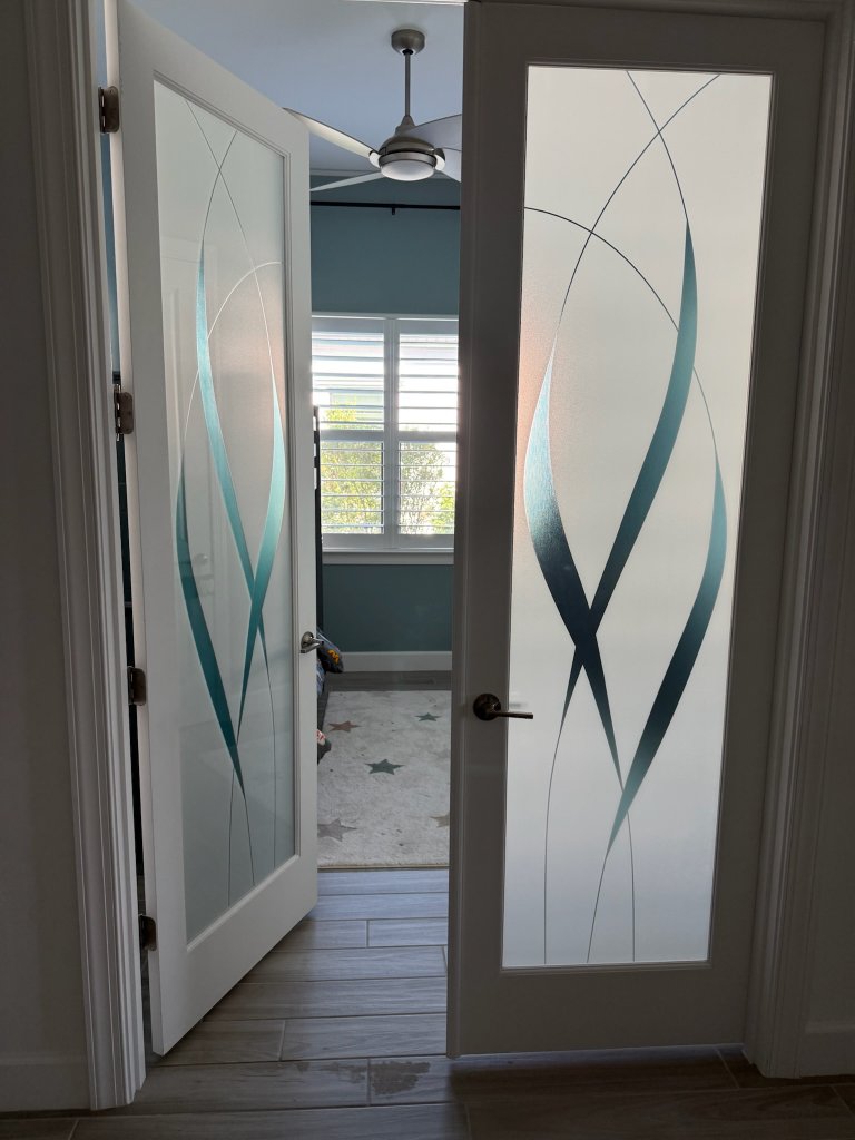 Sweeping accents on partially open double entry doors