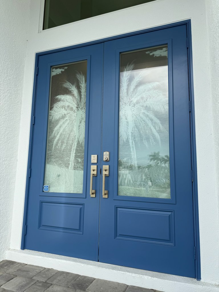 Palm artwork on blue double entry doors