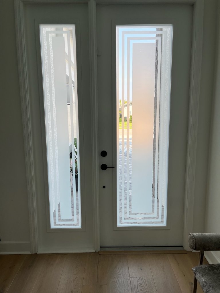 Nested rectangular linework on frosted double entry doors