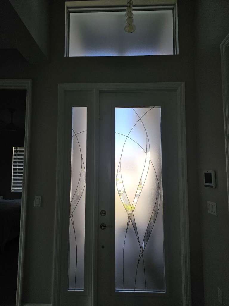 Fine sweeping linework on an entry door and sidelight