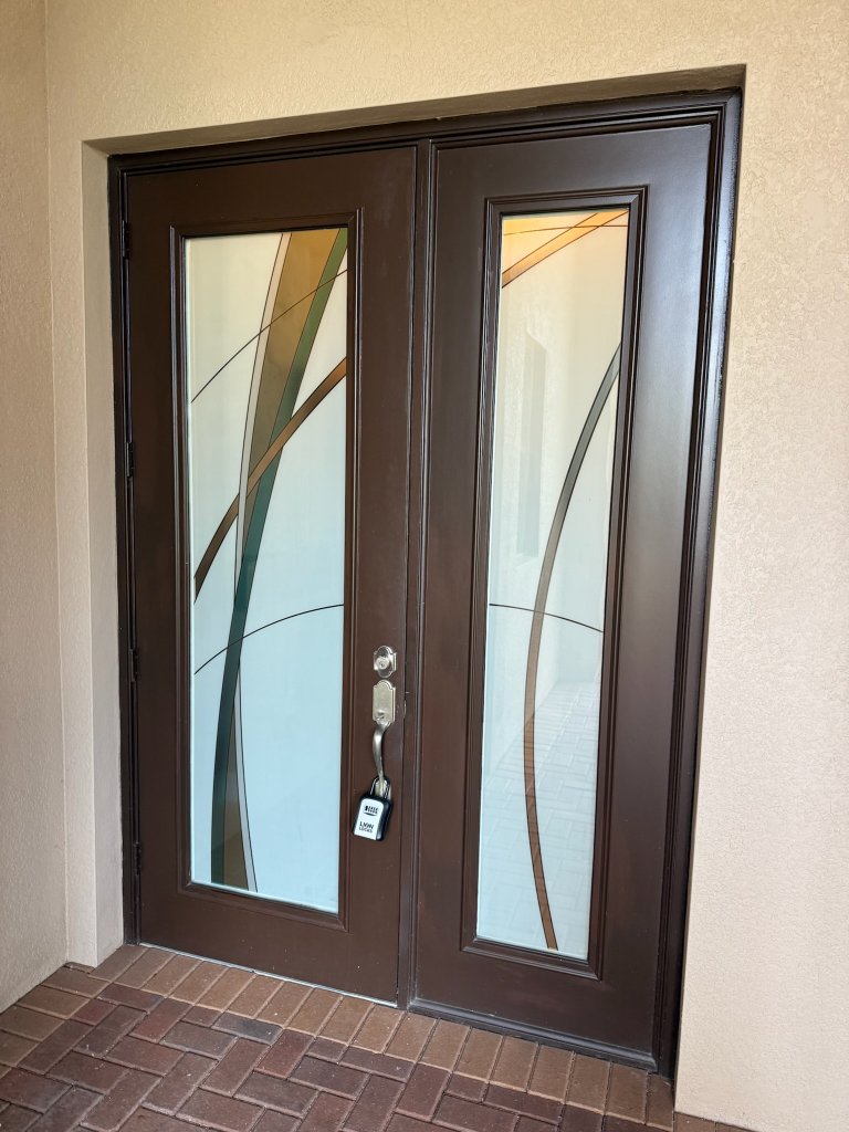 Sweeping dark lines on wood-framed double entry doors