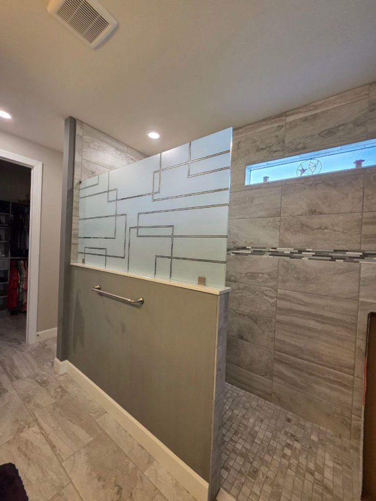 Geometric line accents across shower glass