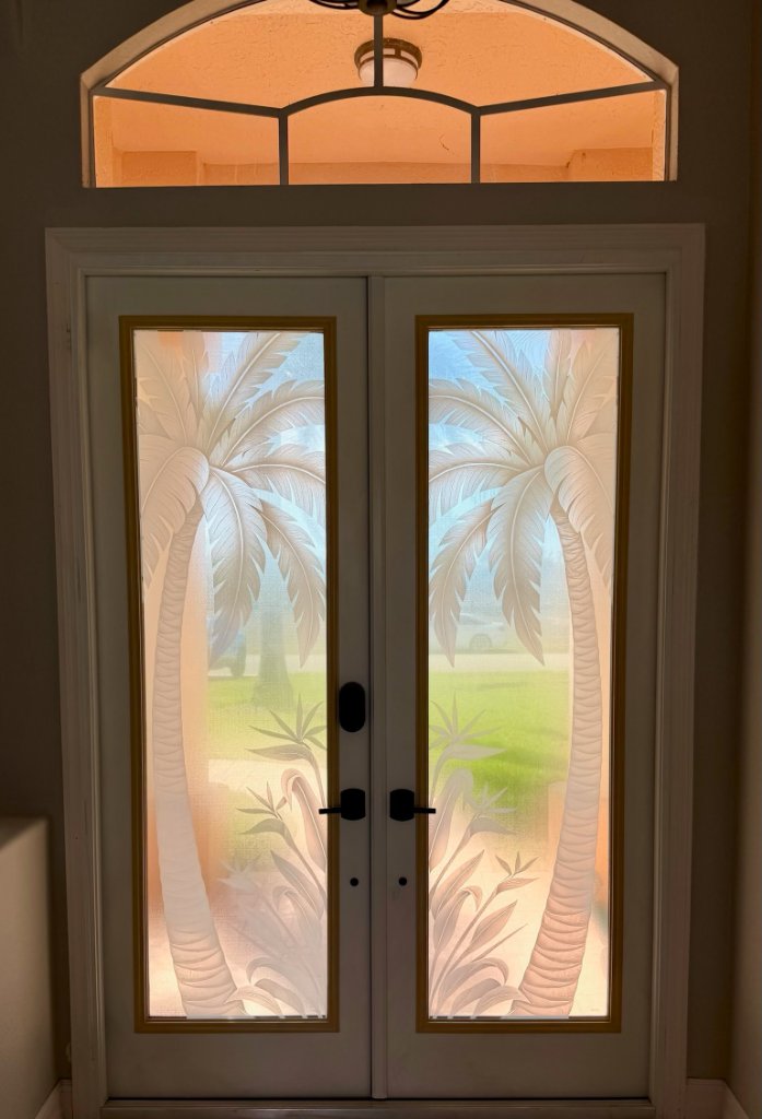 Palm artwork below an arched entry transom