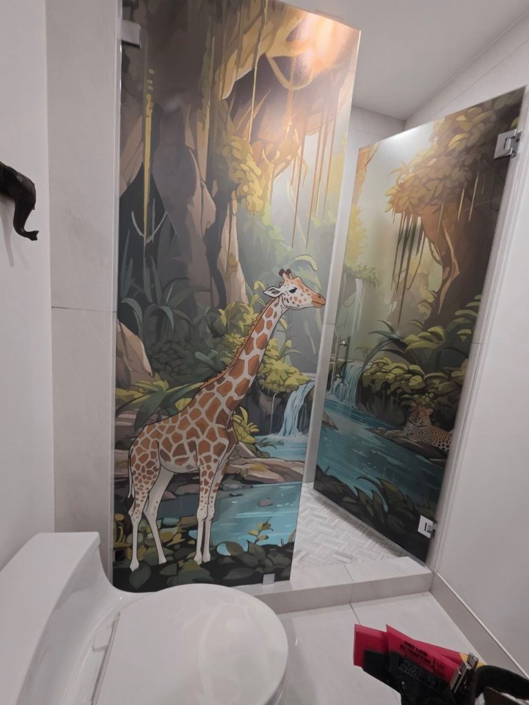 Wildlife scene artwork across bathroom shower glass