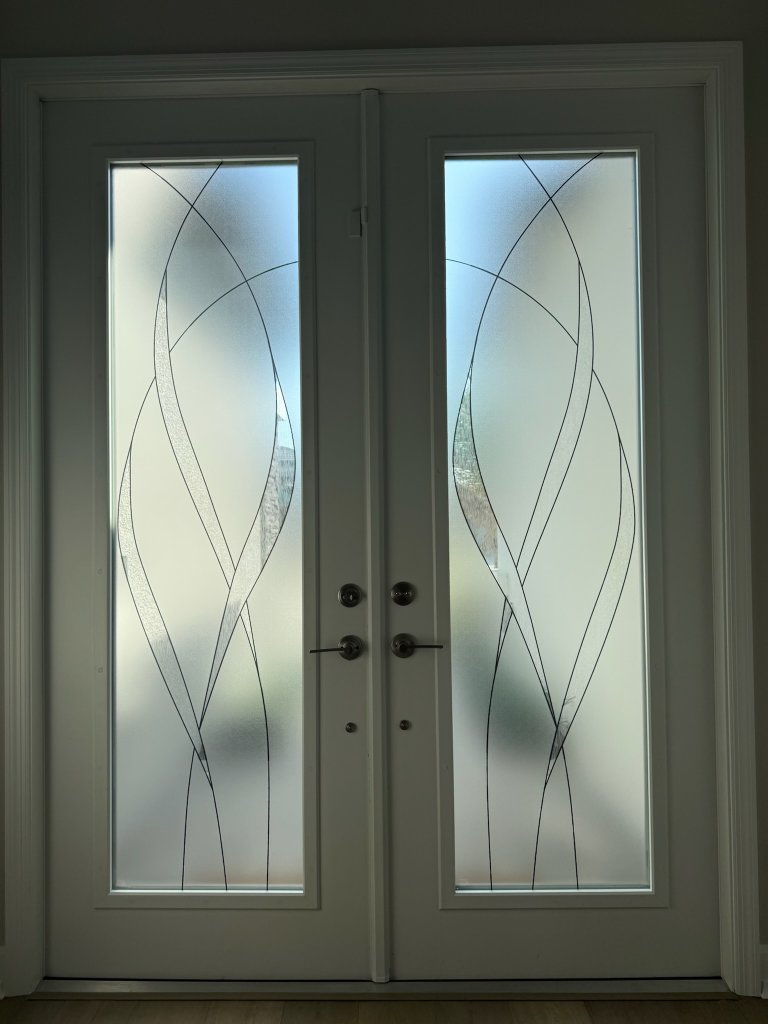 Fine curved linework on white double entry doors