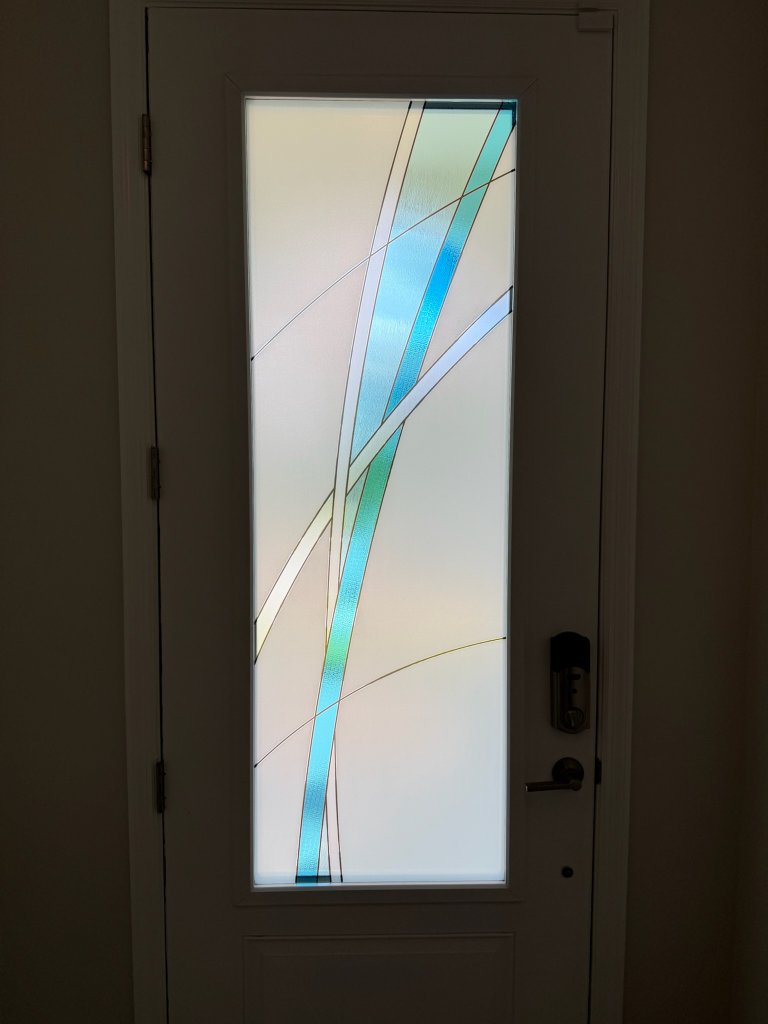 Blue diagonal accent on a narrow entry-door pane