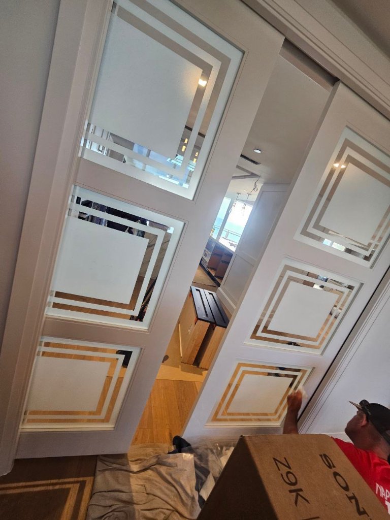 Warm-toned geometric borders on double entry doors