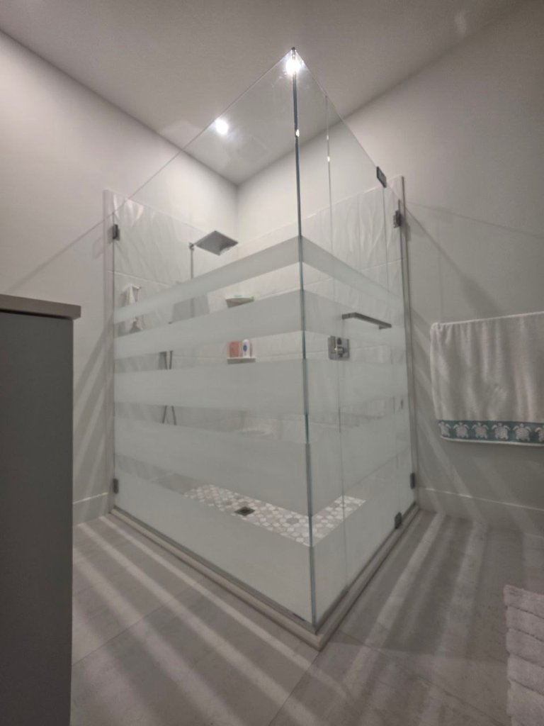 Horizontal clear-and-frosted bands around a glass shower enclosure