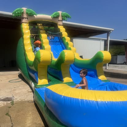 Kids enjoying a bounce house inflatable at a Life Unlimited event