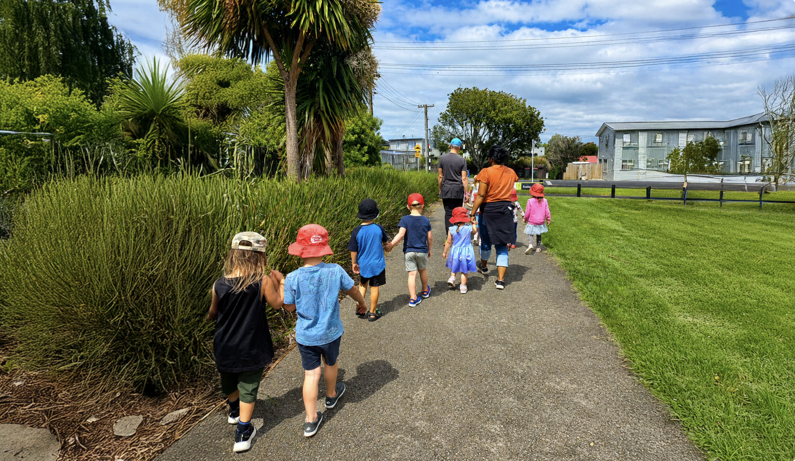 Children and teachers walking together along the reserve path