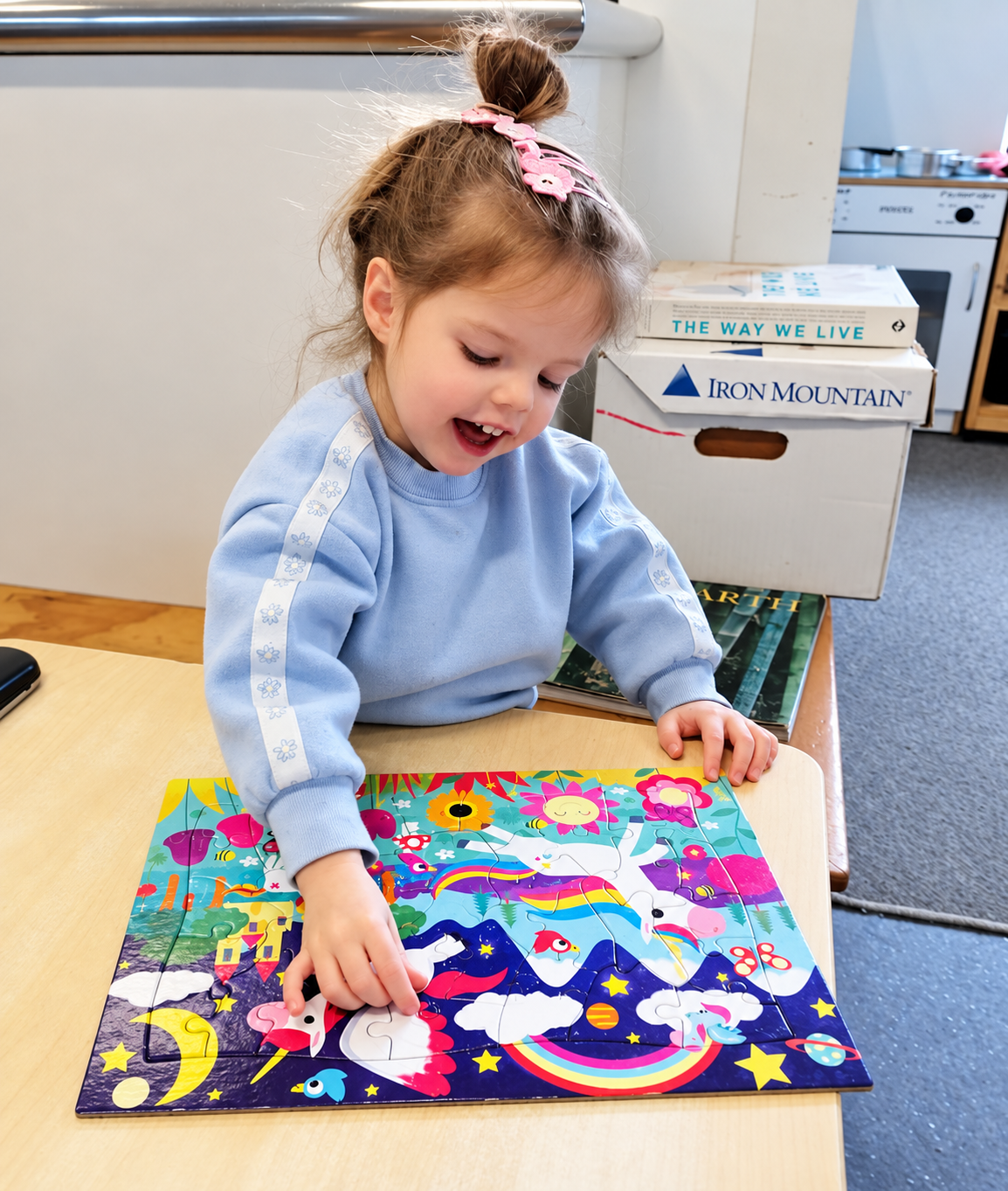 Fledgling completing a unicorn puzzle at the table