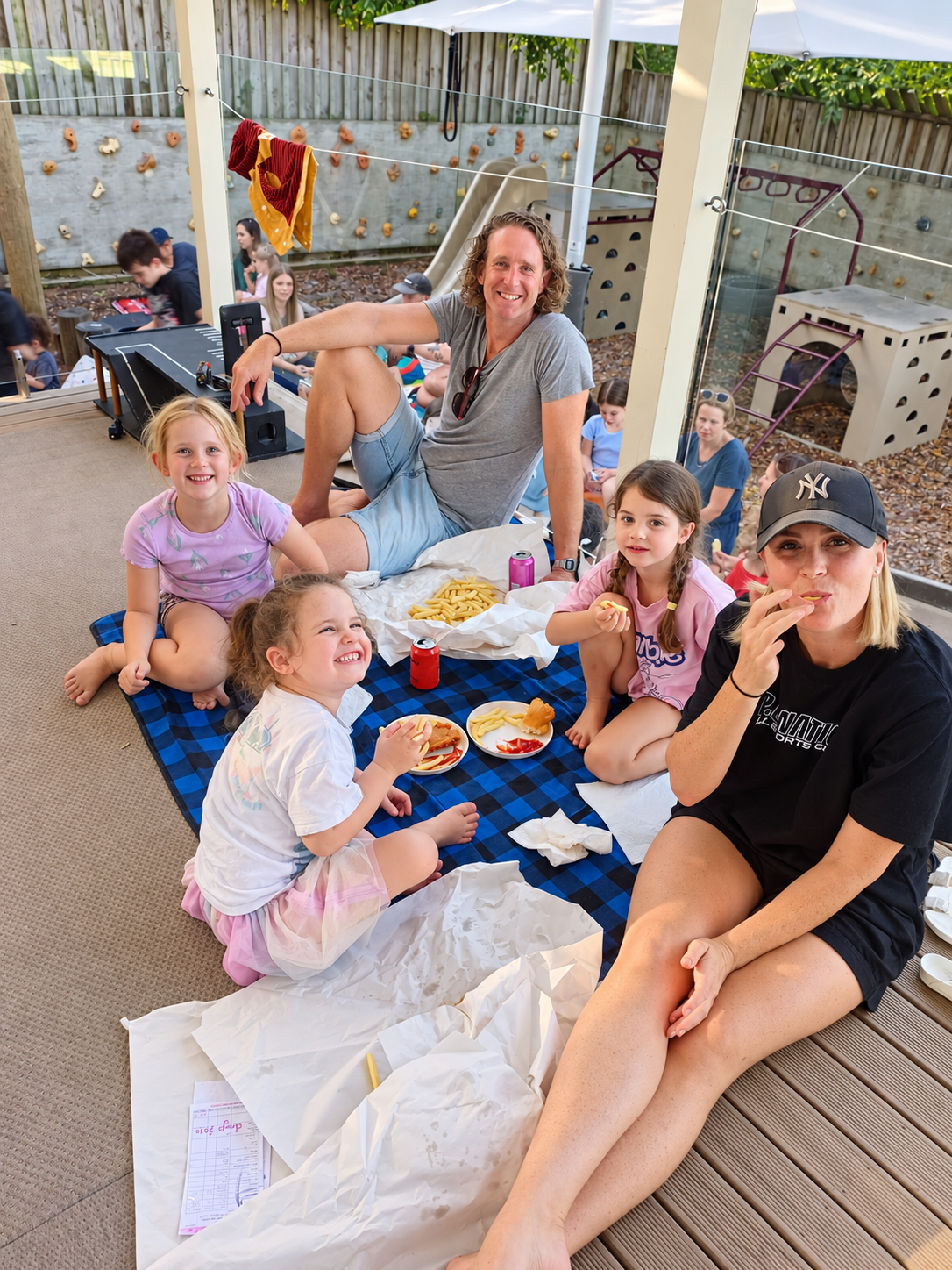Families enjoying a picnic together at a centre event