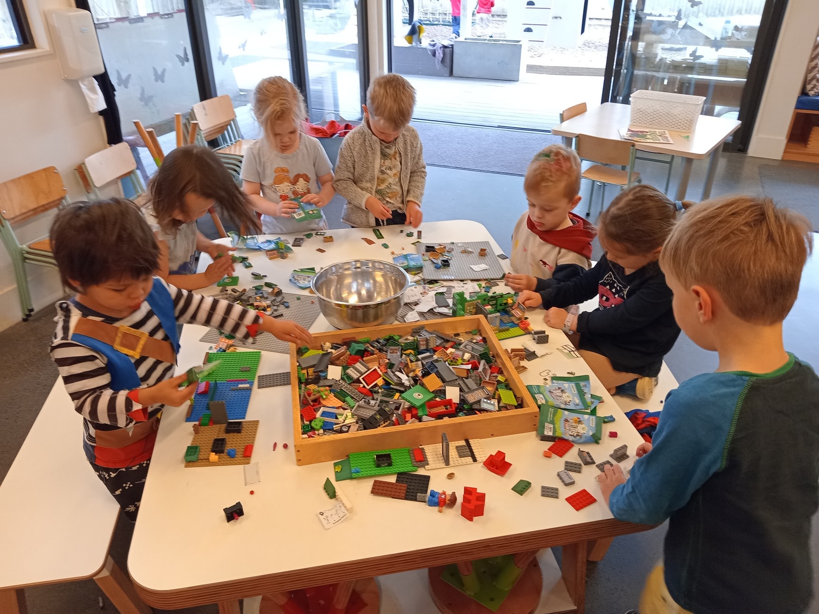 Children building Lego together around a table