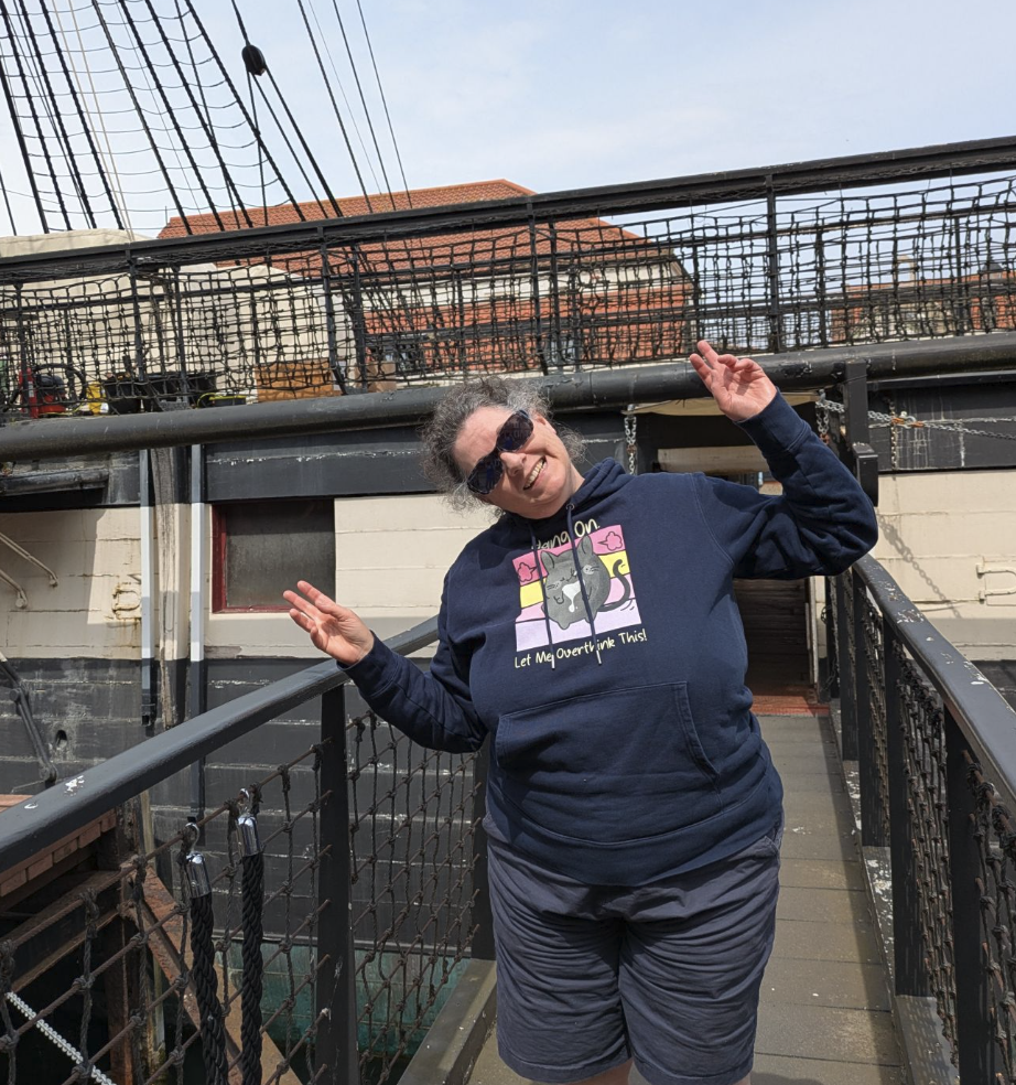Fenella Foxcroft aboard the HMS Trincomalee in Hartlepool, July 2026, making peace signs on the gangway.
