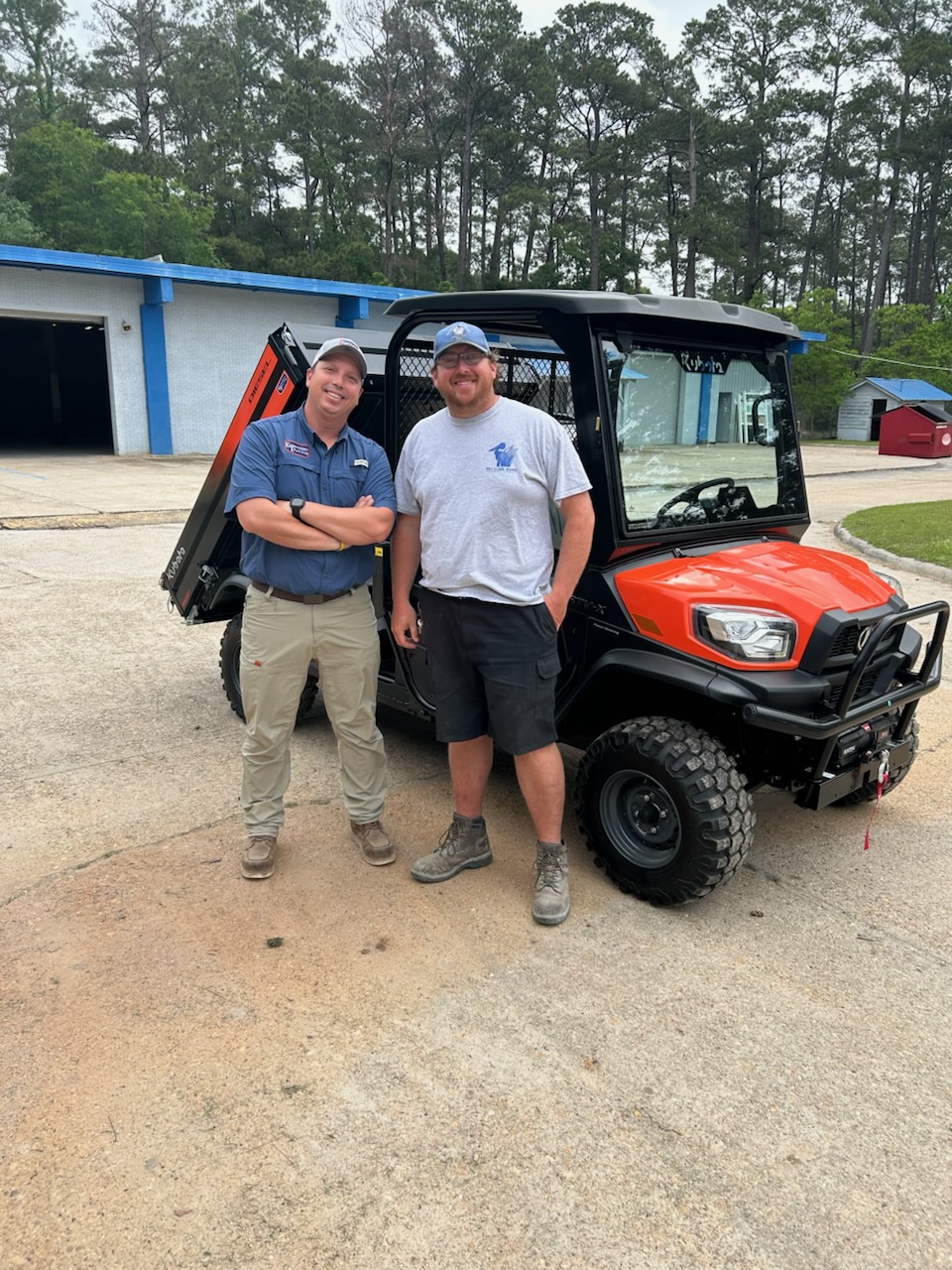 Evergreen Tractor representatives presenting a Kubota RTV-X utility vehicle to a government customer