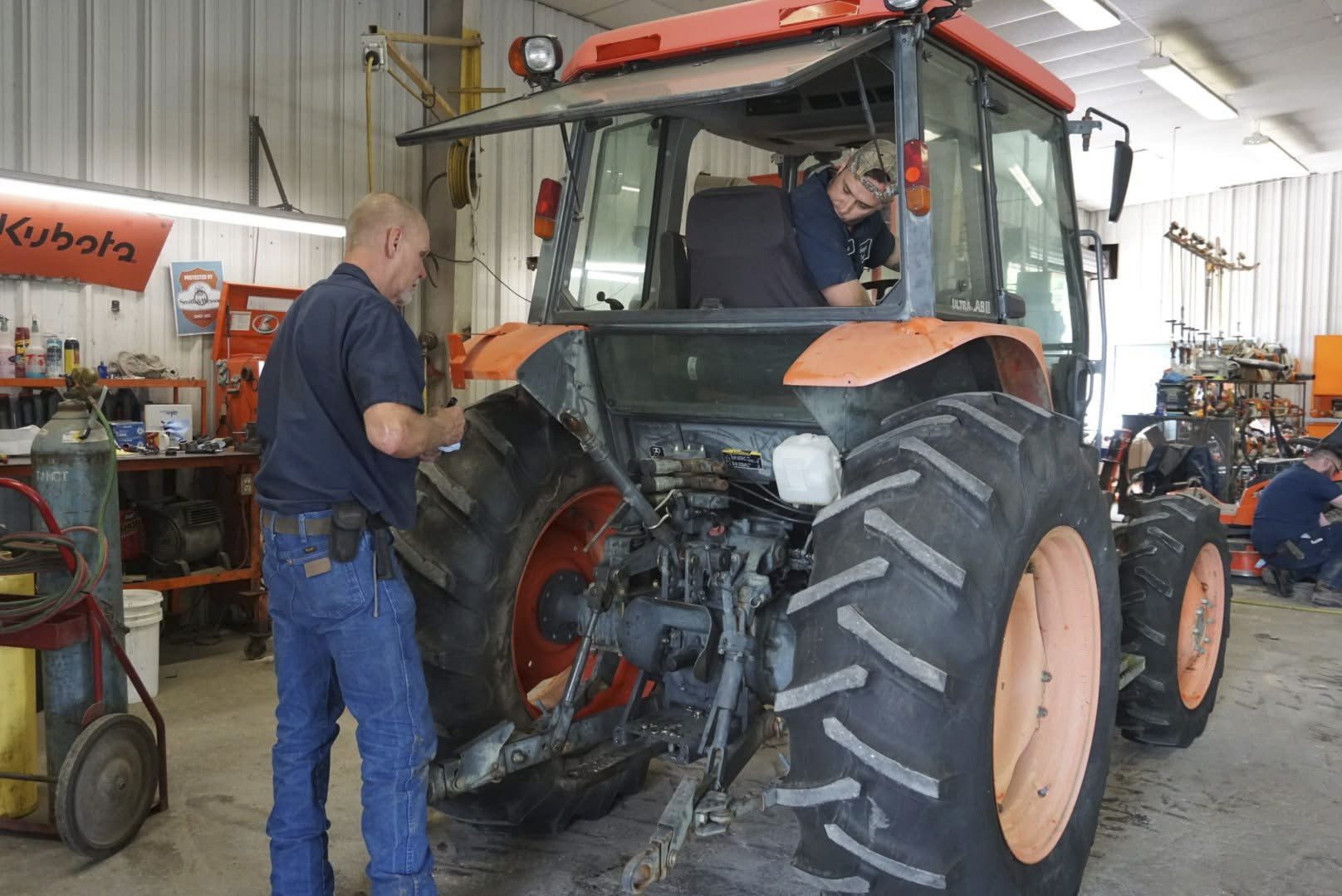 Evergreen Tractor technicians servicing a Kubota tractor inside the service workshop