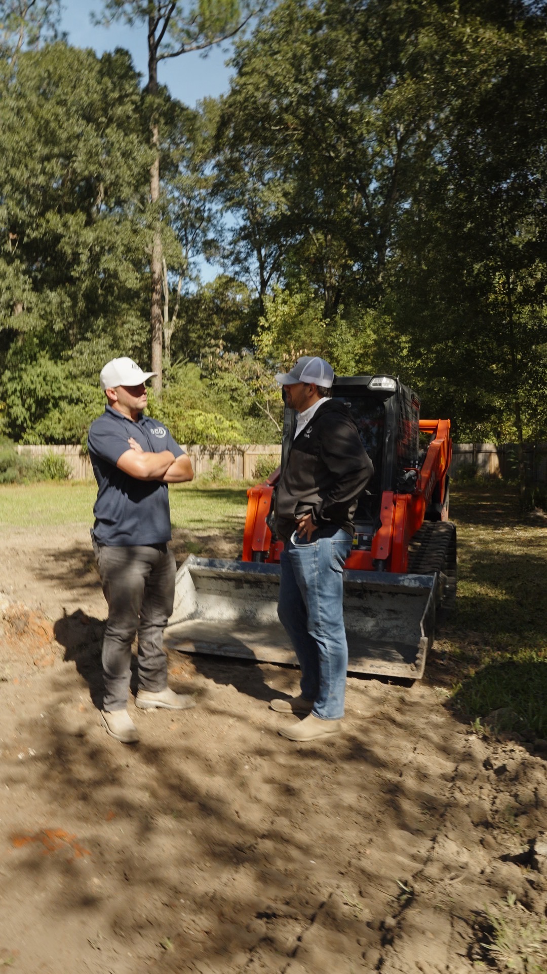 Evergreen Tractor parts specialist delivering parts to a commercial crew at a job site with a Kubota skid steer loader