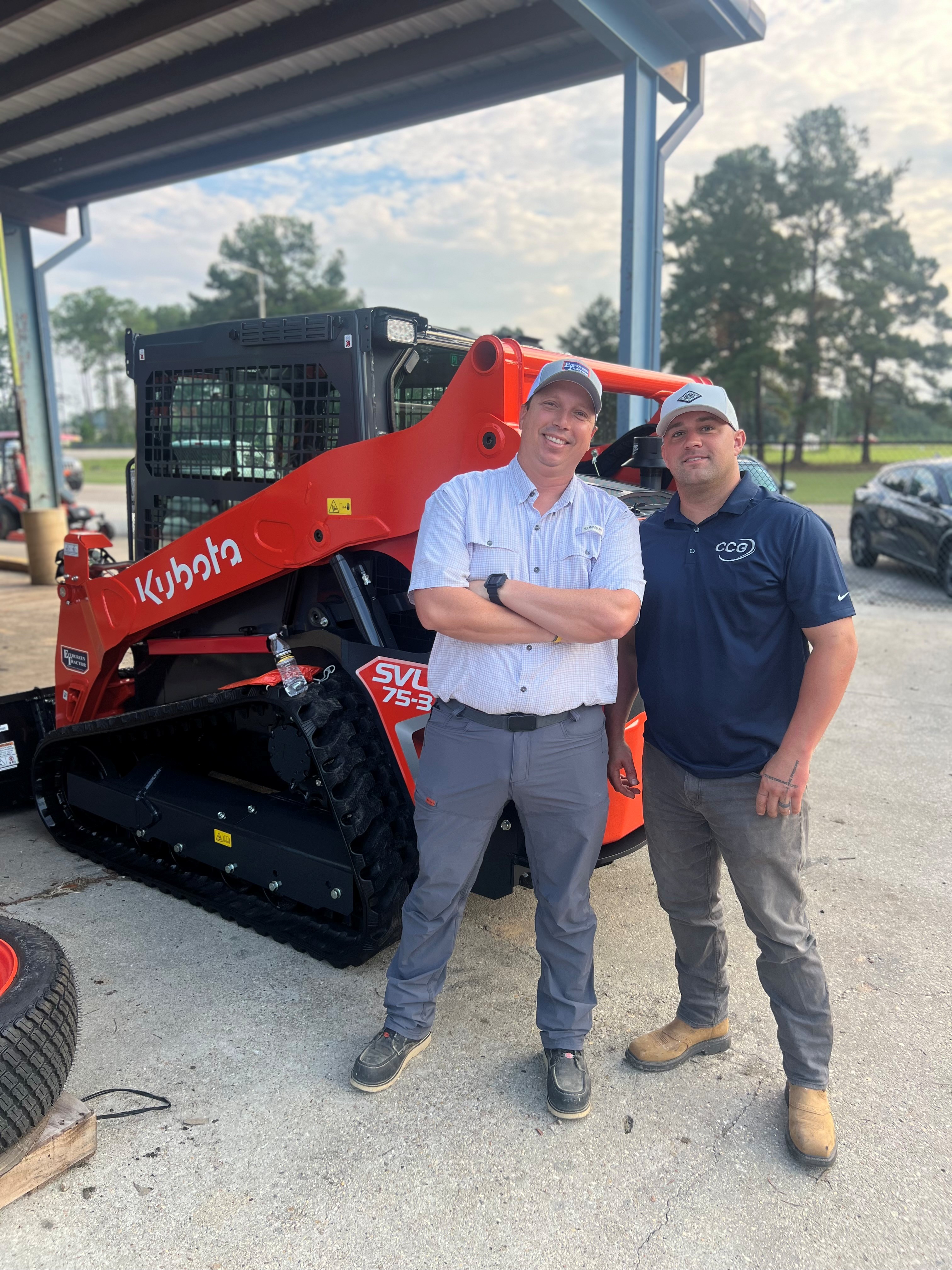 Evergreen Tractor customer standing with his Kubota SVL75-3 skid steer at the dealership in Covington, LA