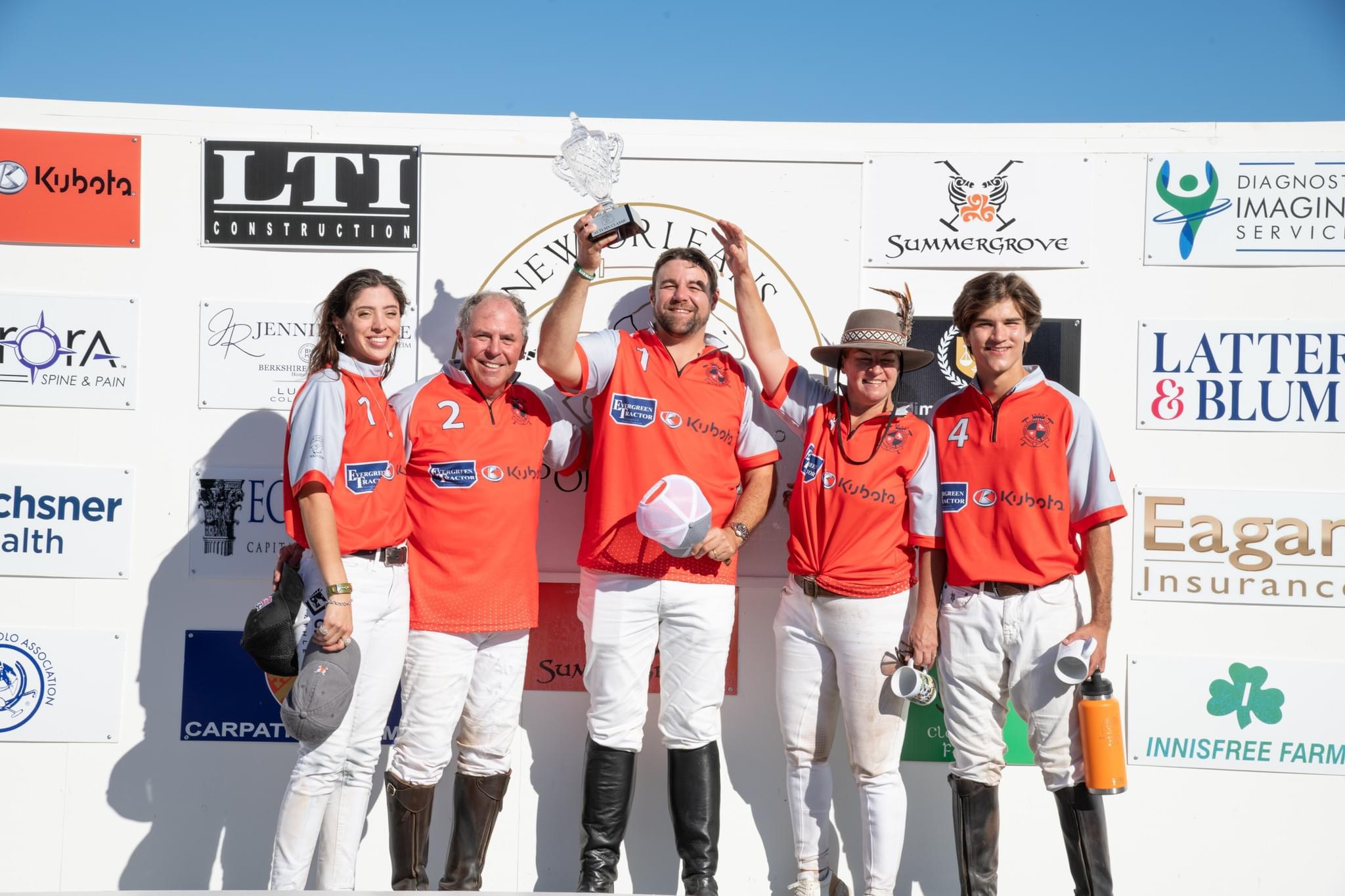 Evergreen Tractor sponsored polo team celebrating a trophy win at Summergrove