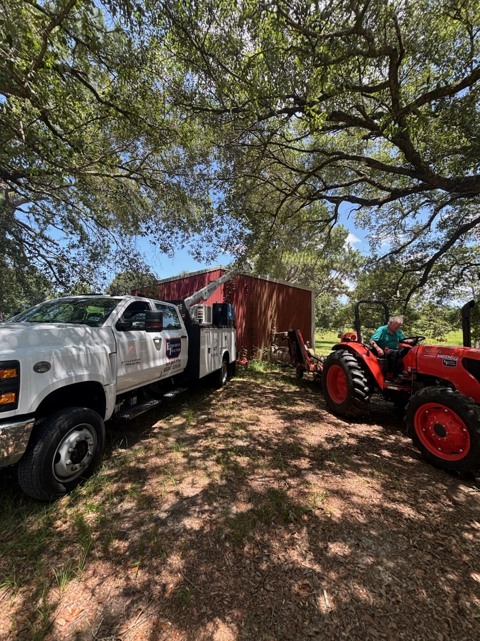 Evergreen Tractor mobile service truck performing on-site maintenance on a customer's tractor