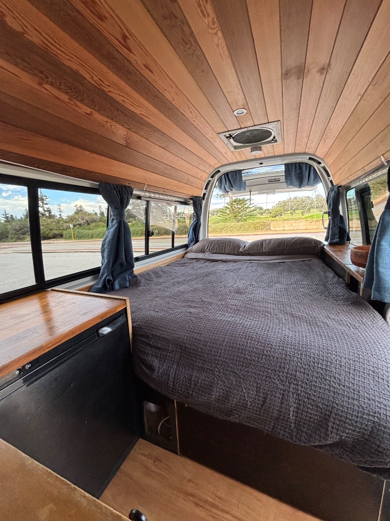 Fixed double bed with timber ceiling