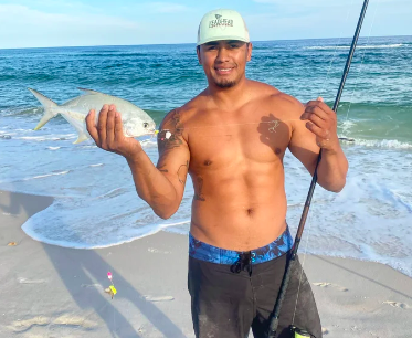Capt. Arinton with a pompano caught surf fishing in Pensacola, FL