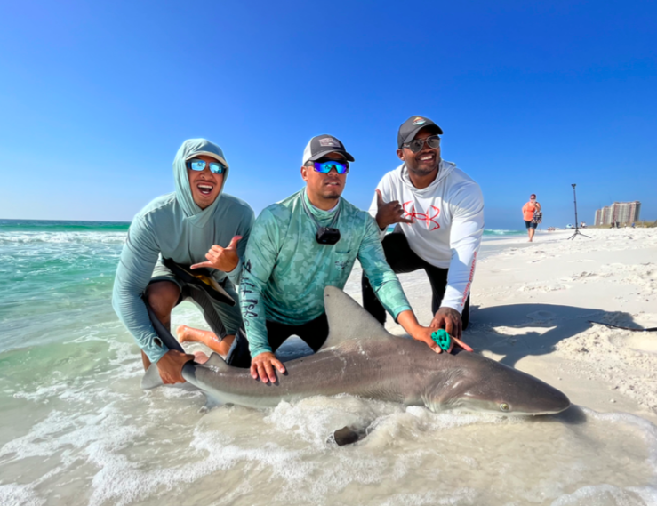 Capt. Arinton with crew and a land-based shark catch in Pensacola, FL