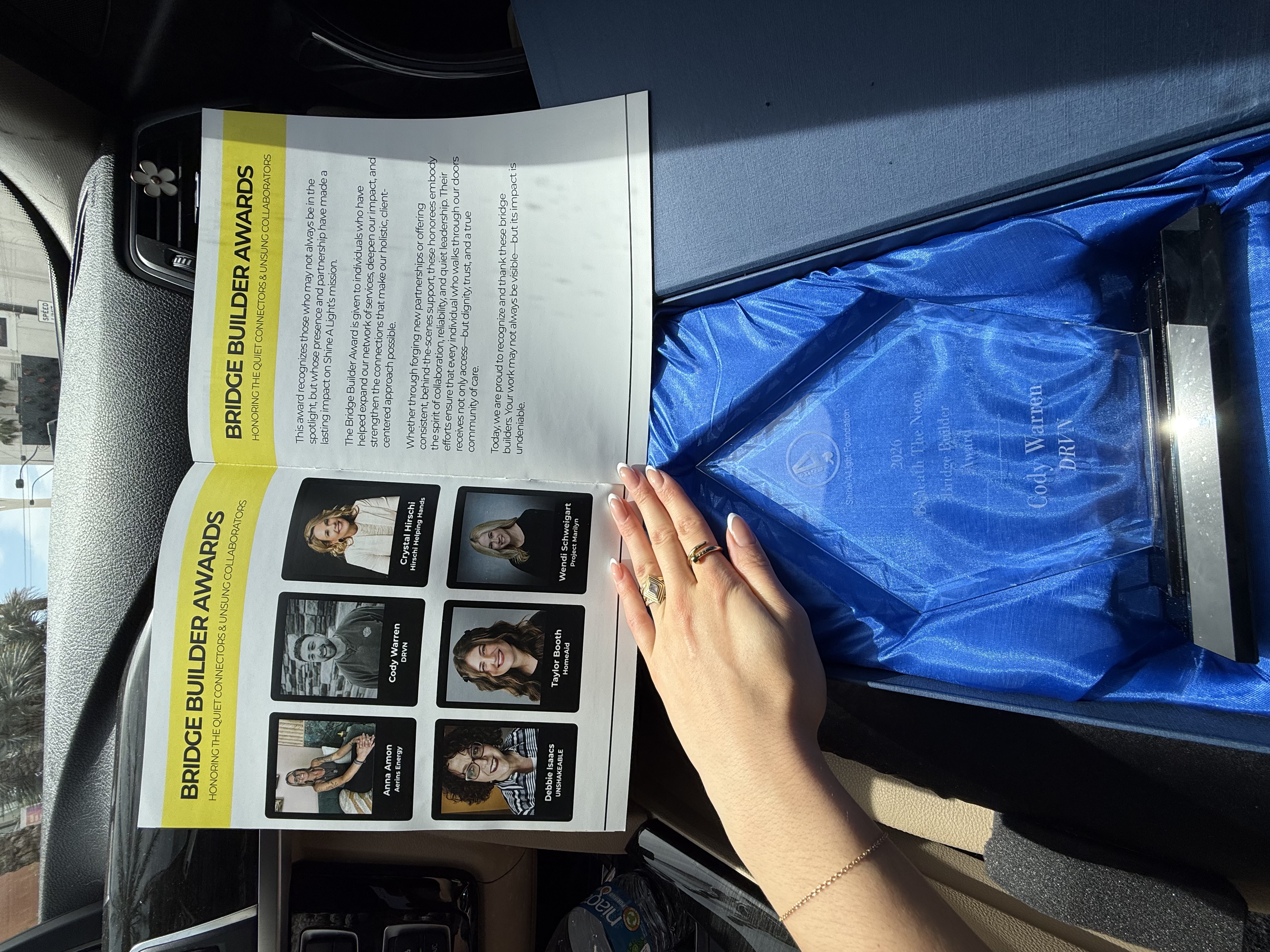Shine A Light Foundation Bridge Builder Awards publication and physical Bridge Builder Award