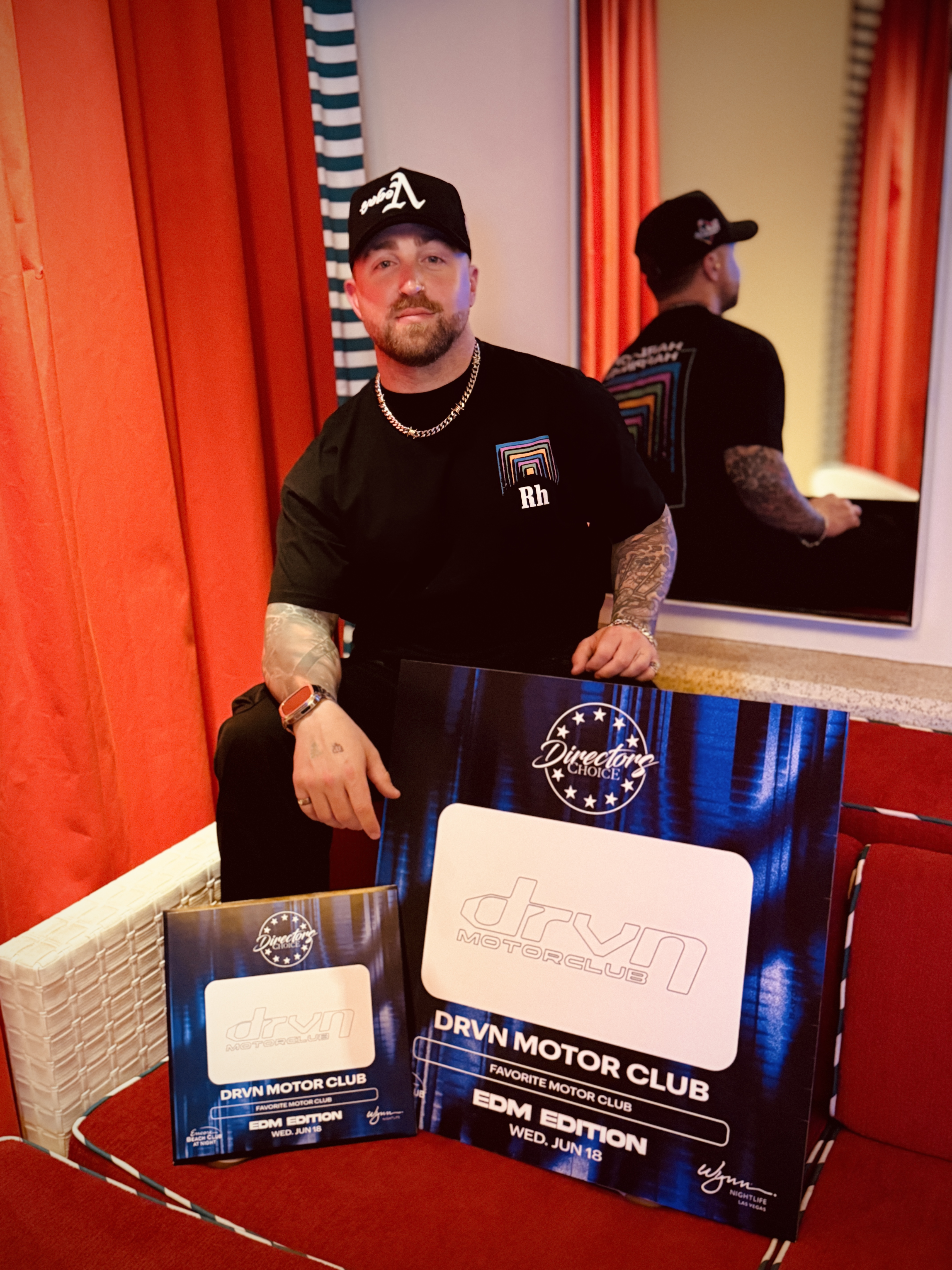 Cody Warren holding the Wynn Nightlife Director’s Choice DRVN Motor Club Favorite Motor Club awards