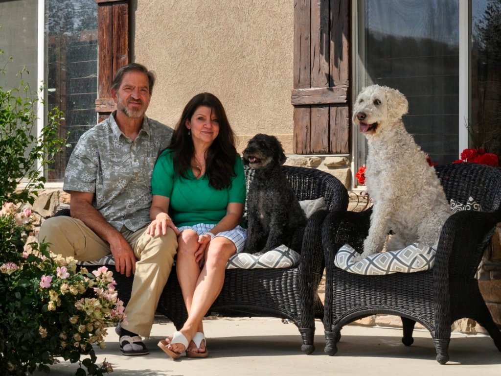 Jeff and Emily with their dogs Lucy and Daisy on their porch