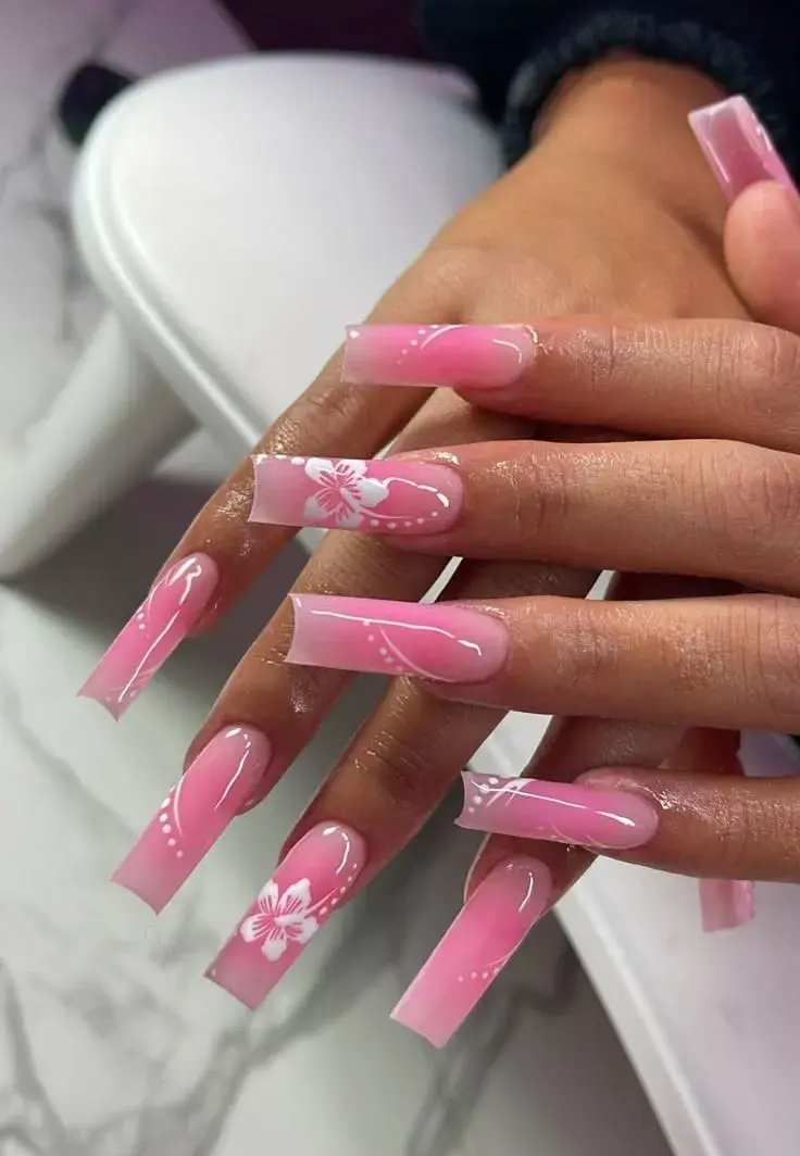 Pink ombre coffin nails with white floral art and swirls