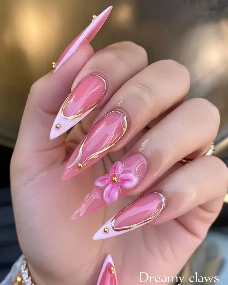 Pink stiletto nails with gold swirl and 3D flower