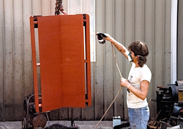 Applying a protective finish coat to fabricated steel components. Proper surface finishing was part of delivering complete, job-ready parts to customers.