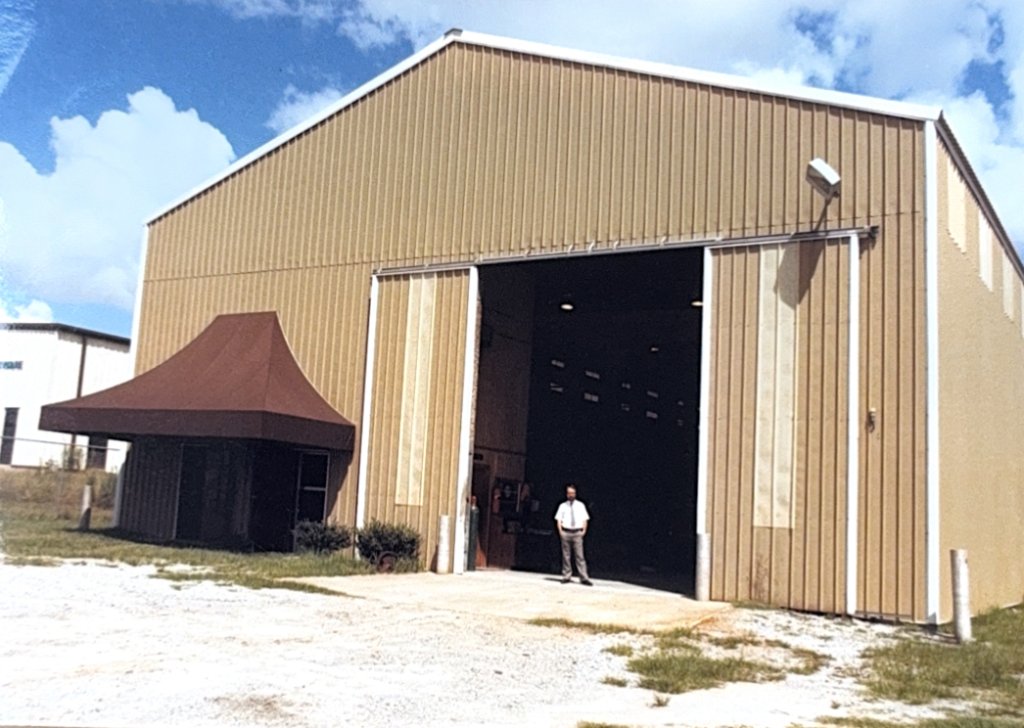 Mack Teston standing at the entrance of the new Garden City facility shortly after relocation.