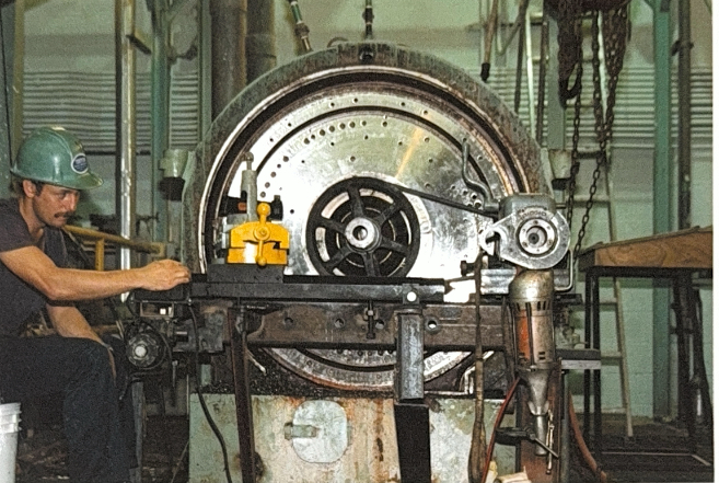 Machinist working on large industrial wheel