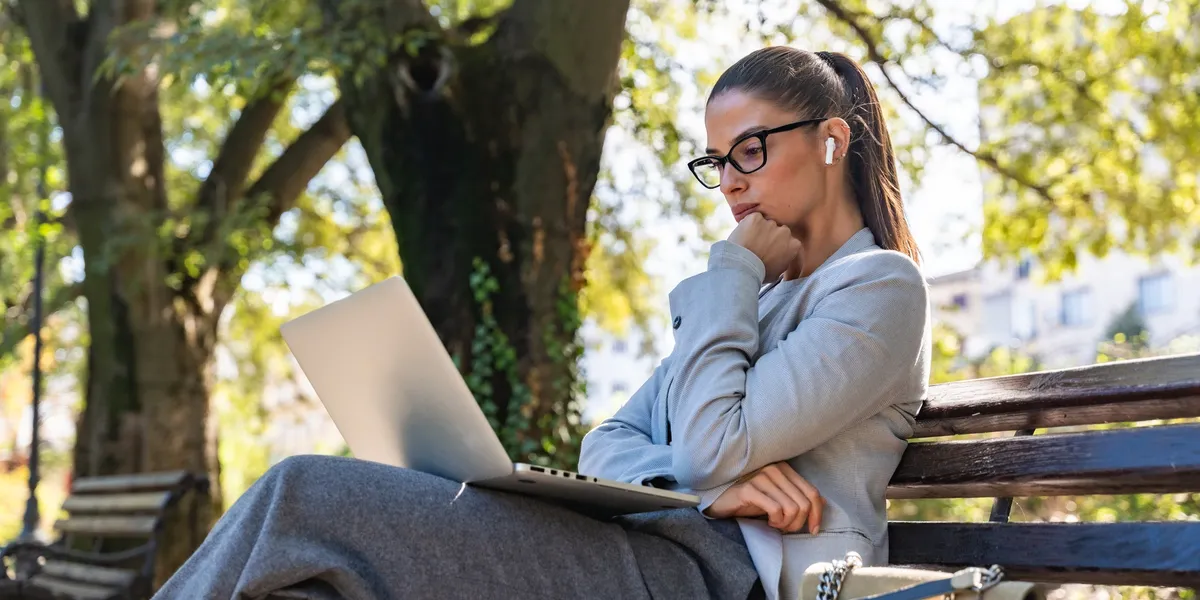 Woman with laptop booking a coaching session