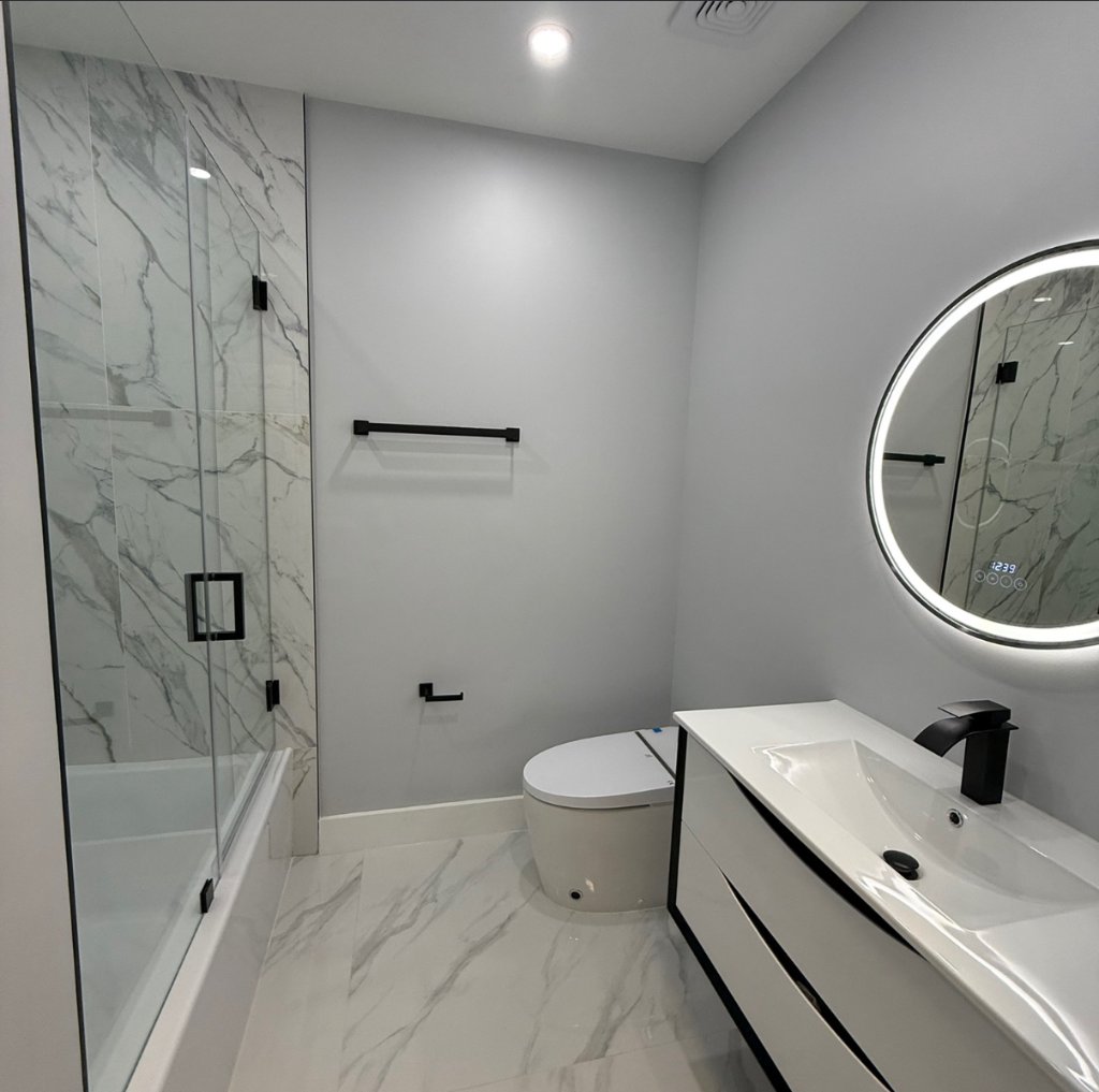 Marble Tile Bathroom with LED Mirror — South Florida by Carbon Haus Construction