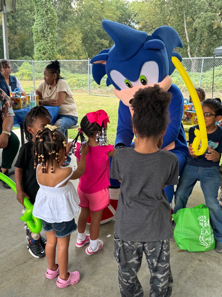Sonic the Hedgehog mascot character with kids at Birmingham party