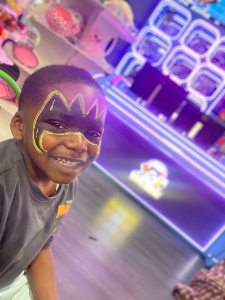 Face painting Birmingham Alabama — colorful mask design on smiling child